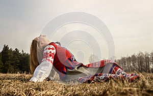 Young woman in Slavic Belarusian national original suit outdoors