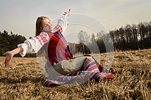 Young woman in Slavic Belarusian national original suit outdoors