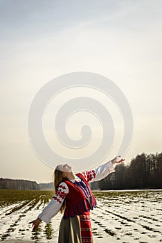 Young woman in Slavic Belarusian national original suit outdoors