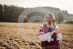 Young woman in Slavic Belarusian national original suit outdoors