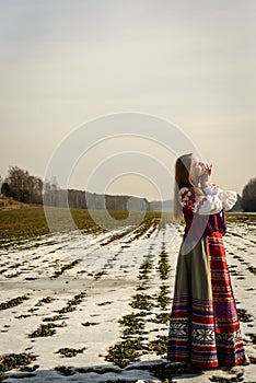 Young woman in Slavic Belarusian national original suit outdoors