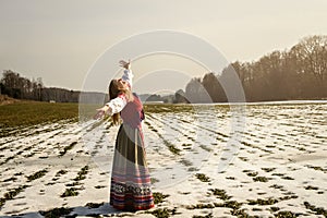 Young woman in Slavic Belarusian national original suit outdoors