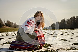 Young woman in Slavic Belarusian national original suit outdoors