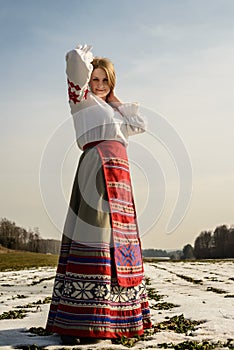 Young woman in Slavic Belarusian national original suit outdoors