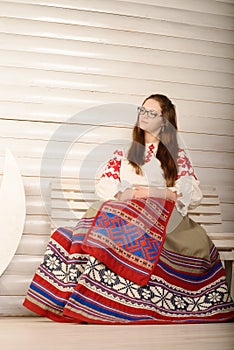 Young woman in Slavic Belarusian national original suit studio