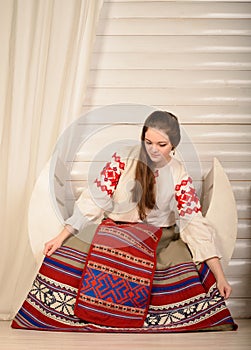 Young woman in Slavic Belarusian national original suit studio