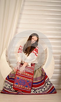 Young woman in Slavic Belarusian national original suit studio