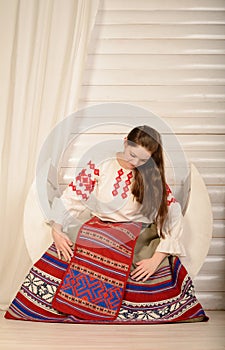 Young woman in Slavic Belarusian national original suit studio