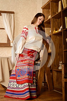 Young woman in Slavic Belarusian national original suit studio