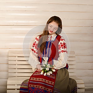 Young woman in Slavic Belarusian national original suit studio