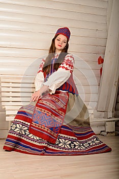 Young woman in Slavic Belarusian national original suit studio