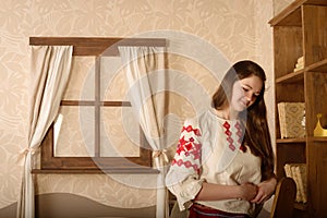 Young woman in Slavic Belarusian national original suit studio