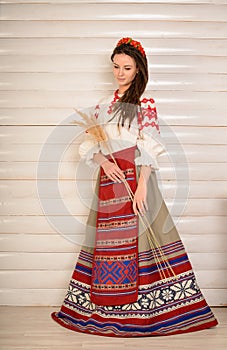 Young woman in Slavic Belarusian national original suit studio