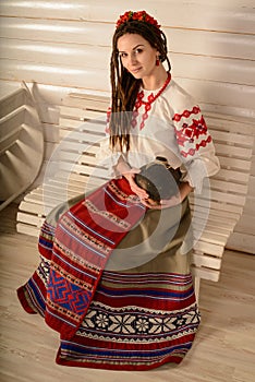 Young woman in Slavic Belarusian national original suit studio