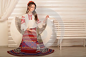 Young woman in Slavic Belarusian national original suit studio