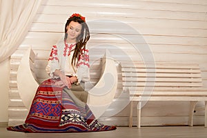 Young woman in Slavic Belarusian national original suit studio