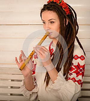 Young woman in Slavic Belarusian national original suit studio