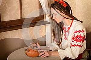 Young woman in Slavic Belarusian national original suit studio