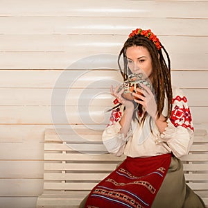 Young woman in Slavic Belarusian national original suit studio