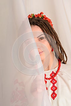 Young woman in Slavic Belarusian national original suit studio