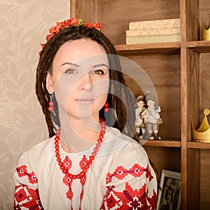 Young woman in Slavic Belarusian national original suit studio