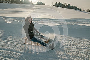 Young woman sledding in the Bavarian alps