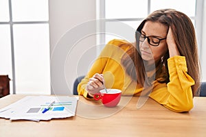 Young woman sleeped drinking coffee at office photo