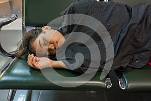 Young woman sleeping in the airport