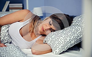 Young woman sleeping in bed