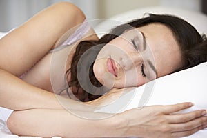 Young Woman Sleeping On Bed