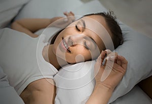 Young Woman Sleeping In Bed Comfortably And Blissfully