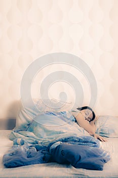 Young woman sleeping on the bed. concept of good sound sleep in a cozy bed. attractive girl lying in bed at home
