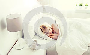 Young woman sleeping in bed at home bedroom