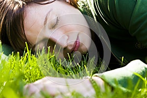 Young woman sleeping on the grass