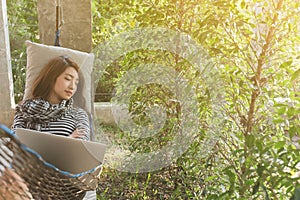Young woman sleeping in hammock while use laptop, freelance life
