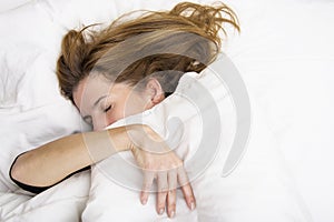 Young woman is sleeping in her bed. photo
