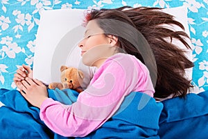 Young woman sleeping with her teddy bear