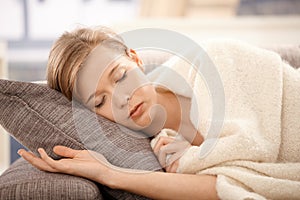 Young woman sleeping on sofa