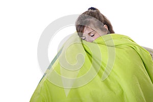 Young woman sleeping under a bedspread