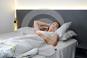 Young woman sleeping well in bed. Teenager girl has good night sleep