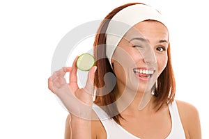 Woman with slice of cucumber