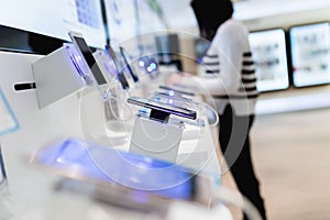 Young woman in smart phone shop