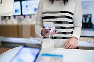 Young woman in smart phone shop
