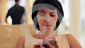 Young woman with smartphone in cafe