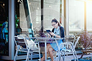 Young woman with smartphone in coffee shop