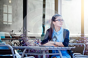 Young woman with smartphone in coffee shop