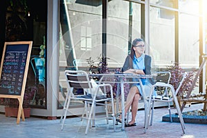 Young woman with smartphone in coffee shop