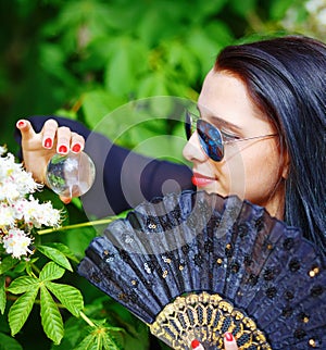 Young woman smelling a beautiful sakura blossom