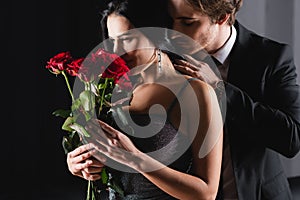 young woman smelling bouquet of red