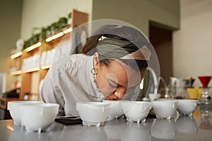 Young Woman Smelling Coffee